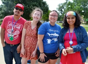Four people standing outside with smiles